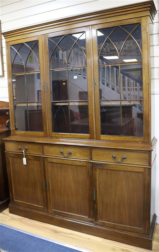 A Georgian style mahogany bookcase, fitted three glazed doors over drawers and cupboards, W.155cm